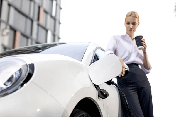 Progressive Businesswoman Electric Car Charging Station Driving City Center Eco — 스톡 사진
