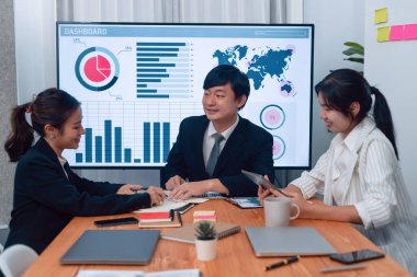 Business team of financial data analysis meeting with business intelligence, report paper and dashboard on laptop for marketing strategy. Business people working together to promote harmony in office.