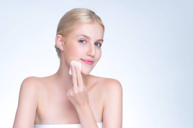 Personable beautiful natural soft makeup woman using powder puff for facial makeup concept. Cushion foundation applying on young girl face in isolated background.