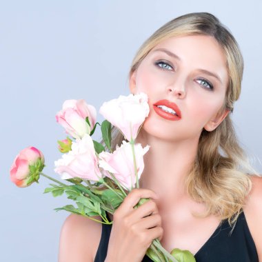 Closeup young woman with alluring flawless makeup and healthy soft skin holding rose for natural skincare treatment advertising in isolated background. Beautiful pretty model girl with flower concept.