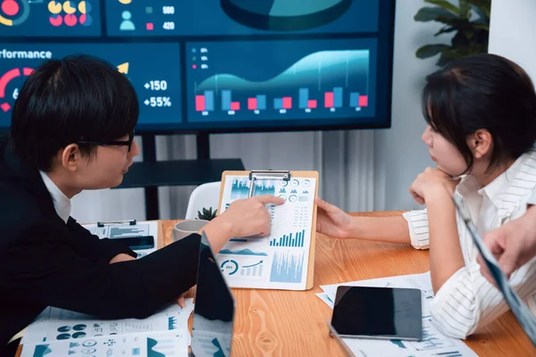 Stock image Business team of financial data analysis meeting with business intelligence, report paper and dashboard on laptop for marketing strategy. Business people working together to promote harmony in office.