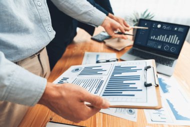 Ofisteki analist ekibi, iş performansını artırmak için bilgisayarında grafik ve çizelge olan BI gösterge panelini kullanarak çalışma alanındaki pazarlama stratejisi için finansal veri analizi yapmakla meşgul. Varlık