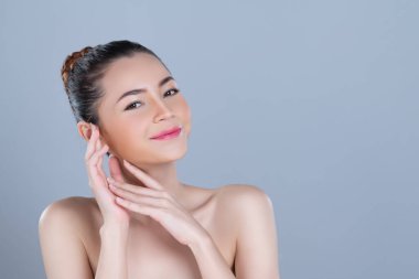 Glamorous woman portrait with perfect smooth pure clean skin with soft cosmetic makeup in isolated background. Beauty hand gesture with expressive facial expression for skincare product or spa ad.