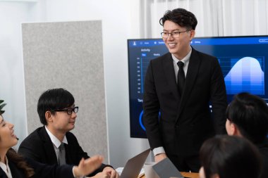 Business team of financial data analysis meeting with business intelligence, report paper and dashboard on laptop for marketing strategy. Business people working together to promote harmony in office.