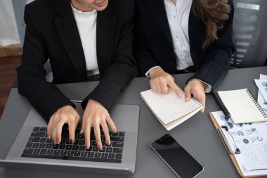 Business team analyze business analytic or business intelligence dashboard on laptop screen show graph and chart with statistic in harmony office. Analyst team meeting researching, planning strategy.