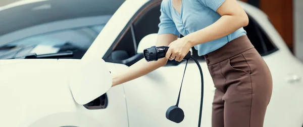 Closeup Progressive Woman Install Cable Plug Her Electric Car Home — ストック写真