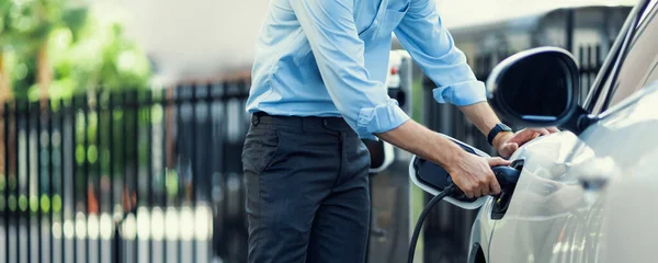 Closeup Progressive Man Holding Charger Plug Public Charging Station Electric — Stok fotoğraf
