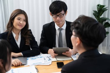 Business team of financial data analysis meeting with business intelligence, report paper and dashboard on laptop for marketing strategy. Business people working together to promote harmony in office.