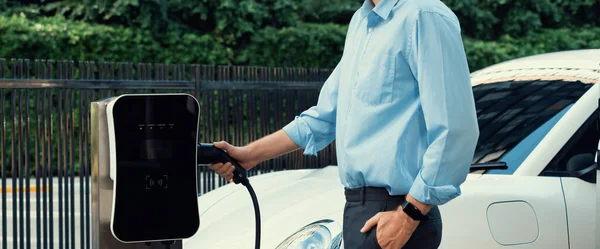 Closeup Progressive Man Holding Charger Plug Public Charging Station Electric — Stock fotografie