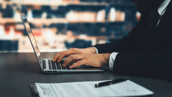 stock image Businessman focused on his laptop working on financial report or planning business strategy in library. Modern office worker utilizing technology in the field of business. Equilibrium