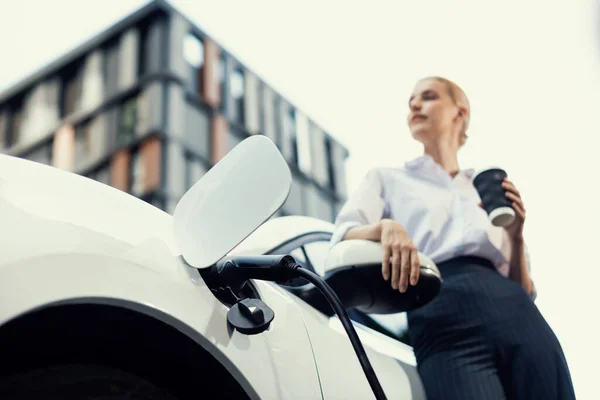 Progressive Businesswoman Electric Car Charging Station Driving City Center Eco — Fotografia de Stock