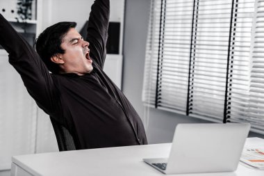 The exhausted asian office worker who was once competent is now confused. Overtime work is causing boredom and exhaustion in the workplace.