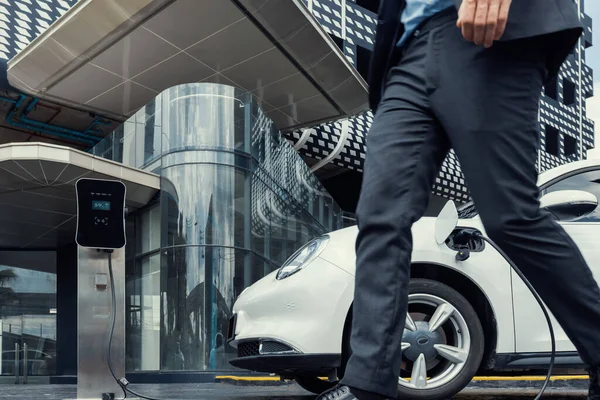 Closeup Progressive Businessman Electric Car Recharging Public Charging Station Background — стоковое фото