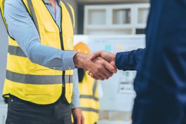 After concluding the meeting, competent investor shakes hands with engineer. Concept of the agreement between engineers and investors.