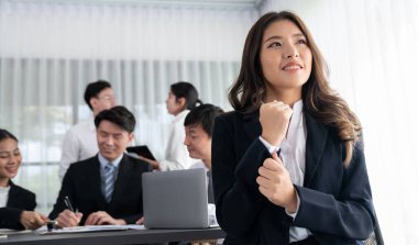 Focus portrait of female manger, businesswoman in the harmony meeting room with blurred of colleagues working together, analyzing financial paper report and dashboard data in background.