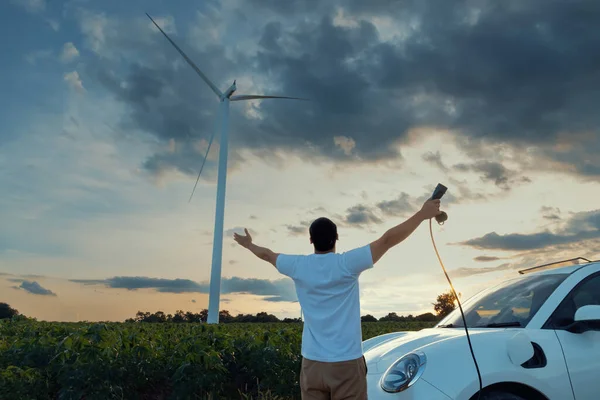 Progressive Man Spread Arm Electric Car Recharge Energy Charging Station — ストック写真