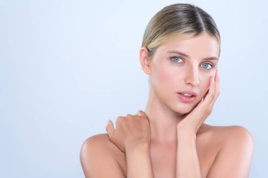 Alluring beautiful woman with perfect smooth and clean skin portrait in isolated background. Beauty hand gesture with expressive facial expression for skincare treatment product or spa.