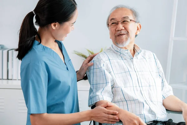 Happy Positive Asian Nurse Giving Support Touching Contented Senior Man — Foto Stock