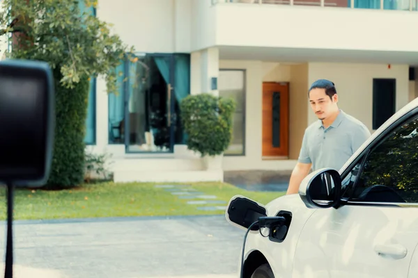 Progressive Asian Man Install Cable Plug His Electric Car Home — Φωτογραφία Αρχείου