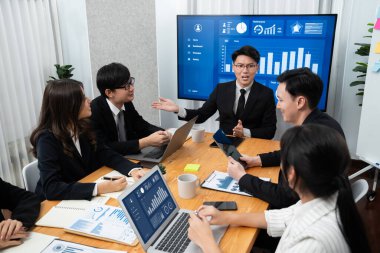 Business team of financial data analysis meeting with business intelligence, report paper and dashboard on laptop for marketing strategy. Business people working together to promote harmony in office.