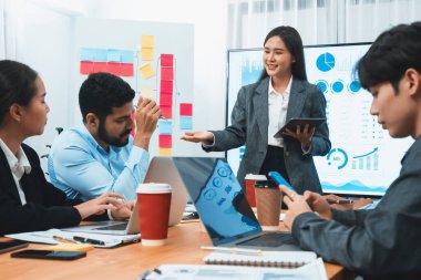 Genç Asyalı iş kadını modern toplantıda TV ekranında veri analizi paneli sunuyor. Bir grup iş adamıyla konferans odasında iş sunumu. Uyum