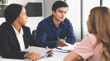 A young female asian candidate tries to impress her interviewer by being competent. International company, multicultural environment in workplace.