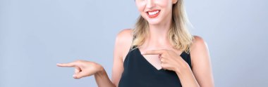 Closeup Alluring beautiful perfect makeup clean skin woman portrait pointing finger side way in copyspace isolated background. Promotion indicated by hand gesture concept for skincare advertisement.
