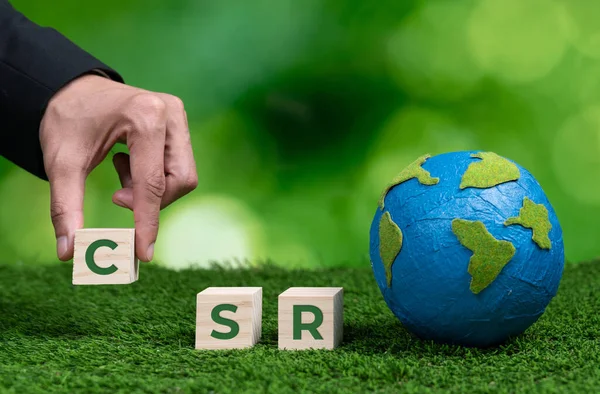 Businessman hand holding gesture with paper globe, CSR symbol cube. Eco-friendly green and ethical business company with no CO2 emission policy. Corporate social responsible for green community. Alter
