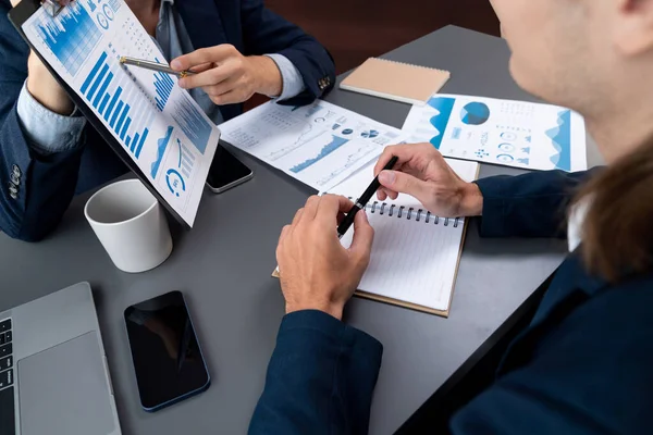 stock image Analyst team in office analyzing financial data analysis for marketing strategy in workspace, pile of BI dashboard paper format with graph and chart to optimize performance and risk management. Entity