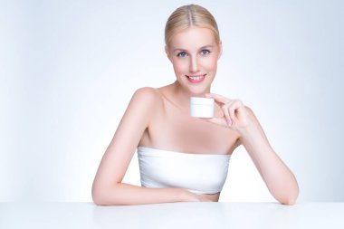 Personable beautiful perfect natural skin woman hold mockup jar moisturizer cream for skincare treatment product advertisement in isolated background with expressive facial and gesture expression.