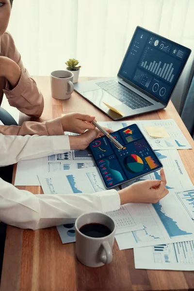 stock image Analyst team colleague discuss financial data on digital dashboard, analyzing charts graph display on laptop and tablet screen. Modern office use business intelligence to plan marketing. Enthusiastic