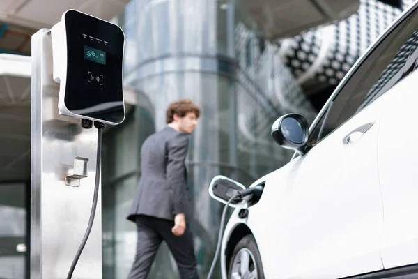 View Progressive Businessman Electric Car Recharging Public Charging Station Modern — Stock Fotó