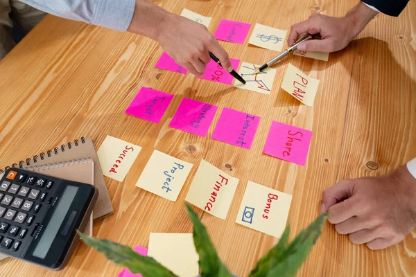 stock image Business team gather on table, brainstorming and writing creative idea on colorful post-it notes. Planning and brainstorm strategy to achieve business targets. fervent