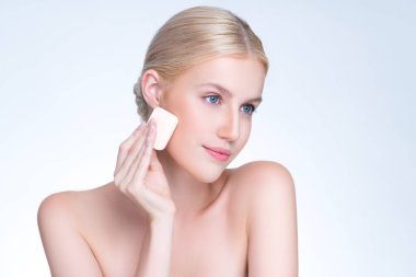 Personable beautiful natural soft makeup woman using powder puff for facial makeup concept. Cushion foundation applying on young girl face in isolated background.
