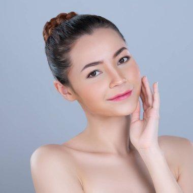 Glamorous woman portrait with perfect smooth pure clean skin with soft cosmetic makeup in isolated background. Beauty hand gesture with expressive facial expression for skincare product or spa ad.