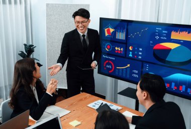 Confidence and asian businessman give presentation on financial analyzed by business intelligence in dashboard report to other people in board room meeting to promote harmony in workplace.