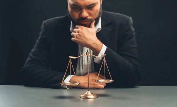 stock image Focus scale balance with blur lawyer sitting at his desk with worried and exhausted expression, feeling weight of pressure and stress of making hard decision on verdict. equility