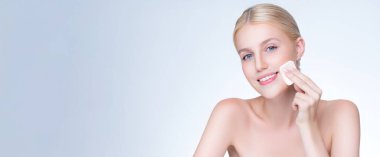 Personable beautiful natural soft makeup woman using powder puff for facial makeup concept. Cushion foundation applying on young girl face in isolated background.