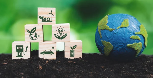Earth model and eco concept wooden icons symbolizing green business utilizing bio power technology and environmental conservation for sustainable eco-friendly energy for clean future. Alter