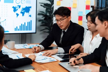 Business team of financial data analysis meeting with business intelligence, report paper and dashboard on laptop for marketing strategy. Business people working together to promote harmony in office.