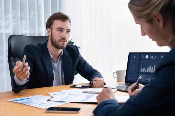 stock image Busy analyst team in office analyzing financial data analysis for marketing strategy in workspace using BI dashboard with graph and chart on laptop screen to improve business performance. Entity