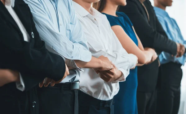 stock image Happy and smiling multiracial office worker hold hand in a line, promoting synergy and collaboration for business success. Diverse professional office worker bond at modern workplace. Concord