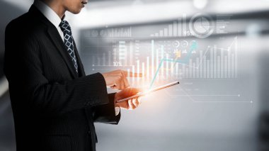 Businessman analyst working with digital finance business data graph showing technology of investment strategy for perceptive financial business decision. Digital economic analysis technology concept.