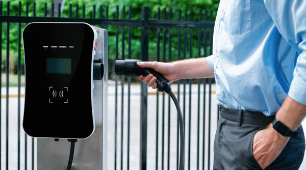 Closeup Progressive Man Holding Charger Plug Public Charging Station Electric — Stock Photo, Image
