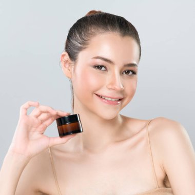 Glamorous beautiful perfect cosmetic skin with soft makeup woman portrait hold mockup jar cream or moisturizer for skincare treatment and anti-aging product advertisement in isolated background.