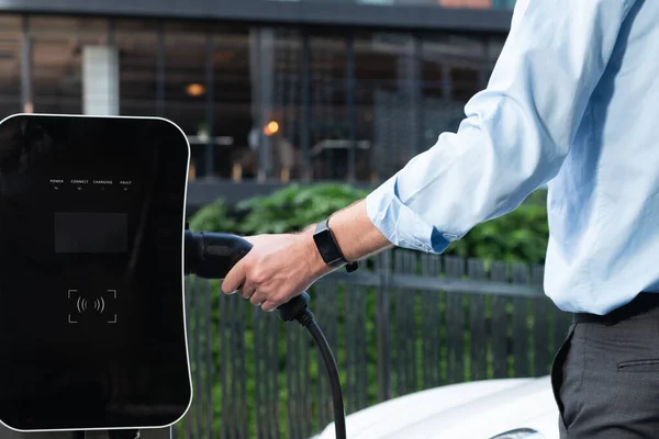 Closeup Progressive Man Holding Charger Plug Public Charging Station Electric — Stock Fotó