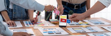 Kağıt kablo arayüzü üzerinde mobil uygulama için UI ve UX tasarımları yapan ön-uç geliştirici ekibin panorama görüntüsü. Kullanıcı dostu UI tasarımı için kullanıcı arayüzü geliştirme ekibi planlama. İnceleyin