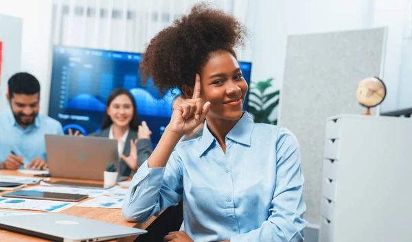 stock image Portrait of happy young african businesswoman with group of office worker on meeting with screen display business dashboard in background. Confident office lady at team meeting. Concord