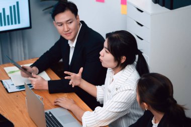 Business team of financial data analysis meeting with business intelligence, report paper and dashboard on laptop for marketing strategy. Business people working together to promote harmony in office.