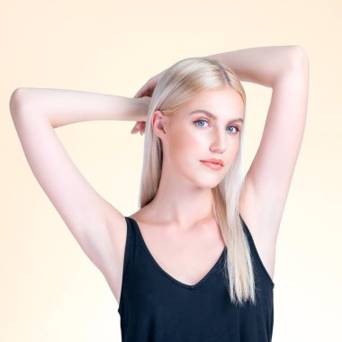 Personable woman lifting her armpit showing hairless hygiene underarm as beauty posing for cleanliness and perfect smooth skincare treatment in isolated background. Hair removal and epilation concept.